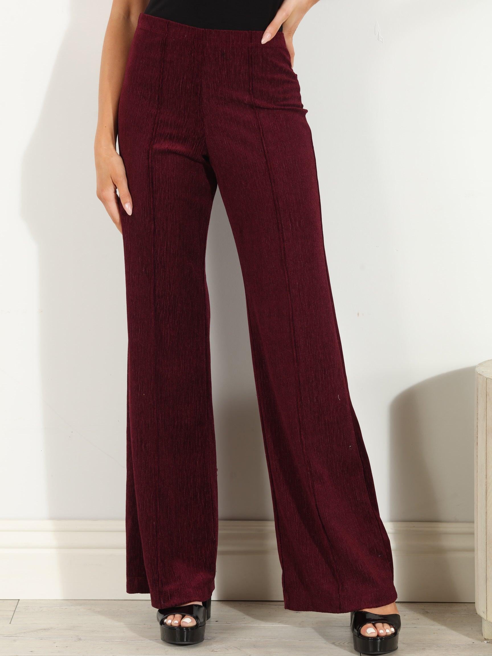 woman in wine colored velvet pants