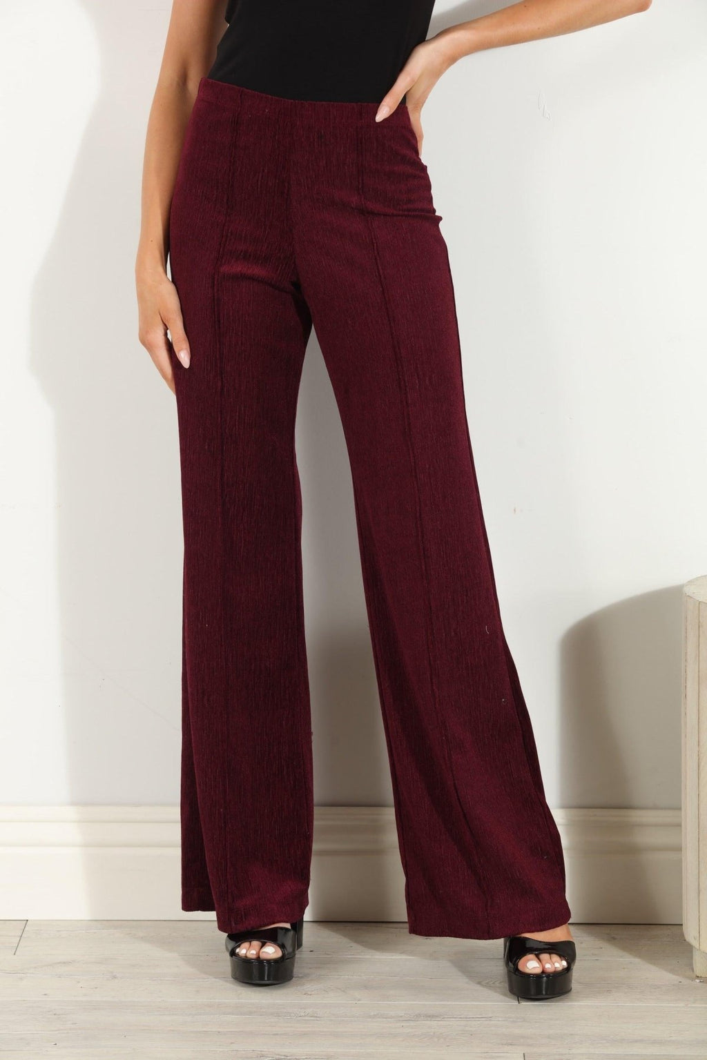 woman in wine colored velvet pants