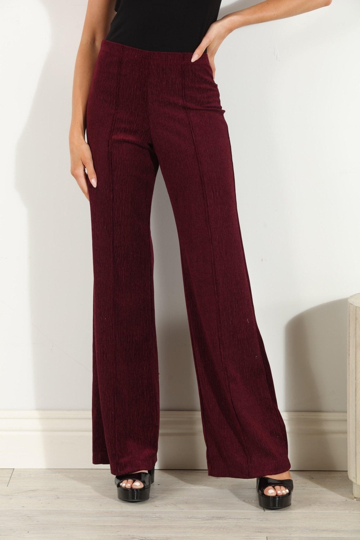 woman in wine colored velvet pants