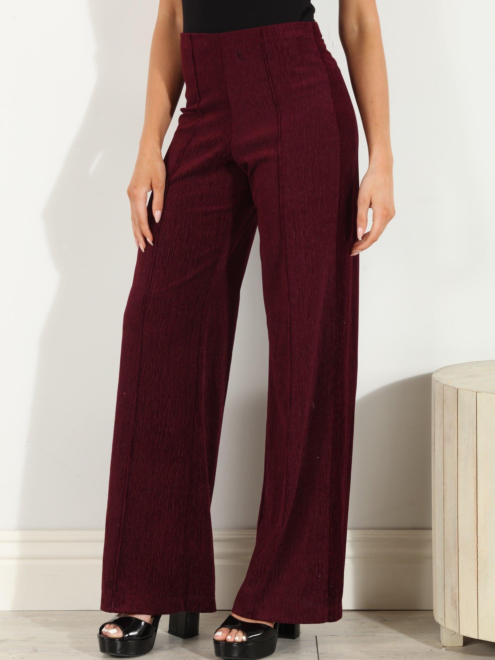 woman in wine colored velvet pants