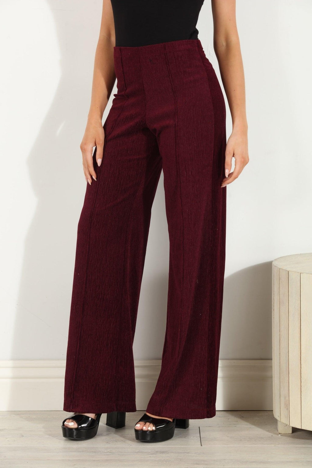 woman in wine colored velvet pants