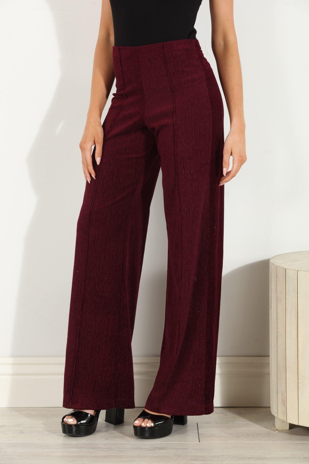woman in wine colored velvet pants