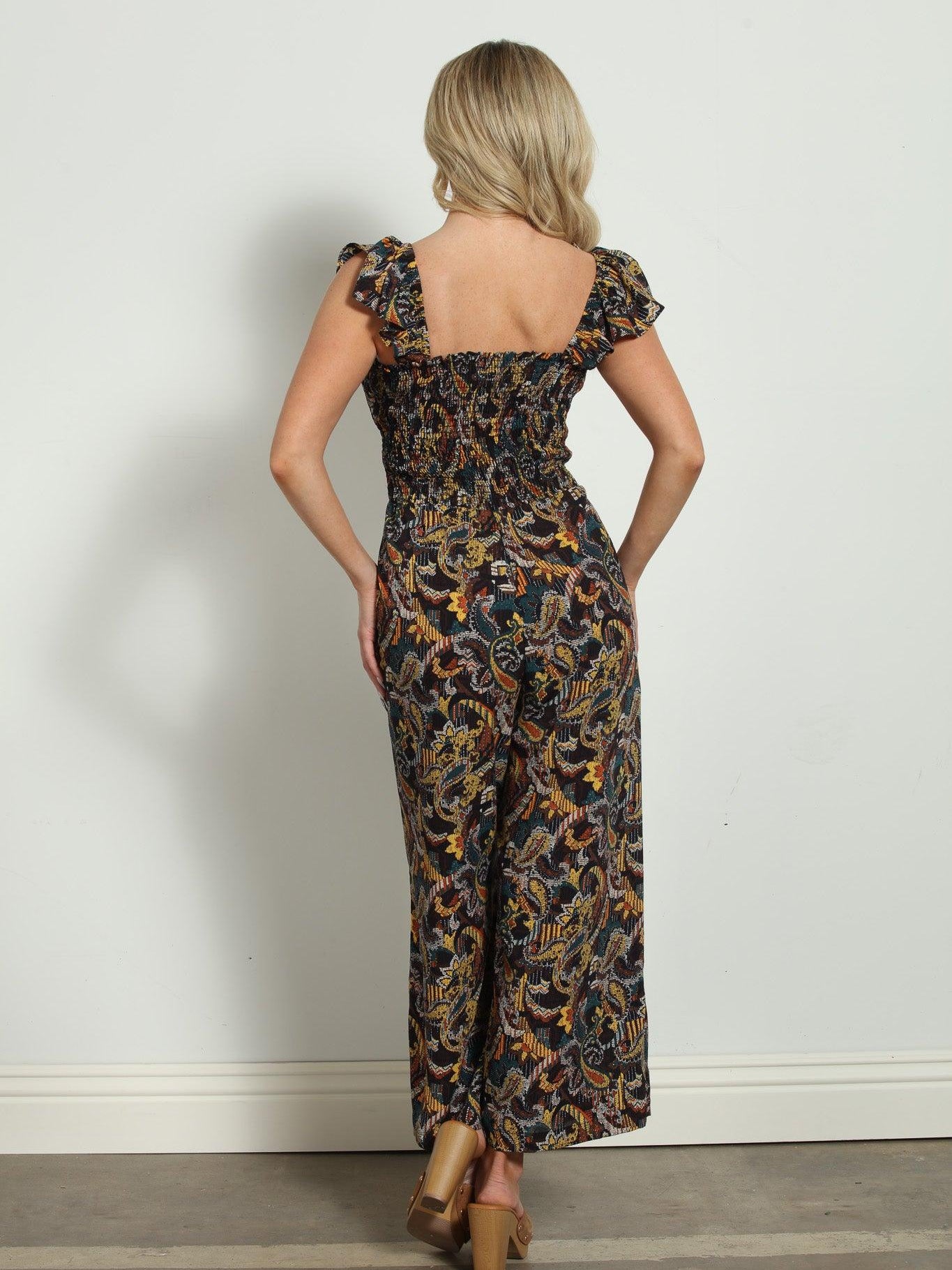 backside of woman in multicolored sleeveless jumpsuit