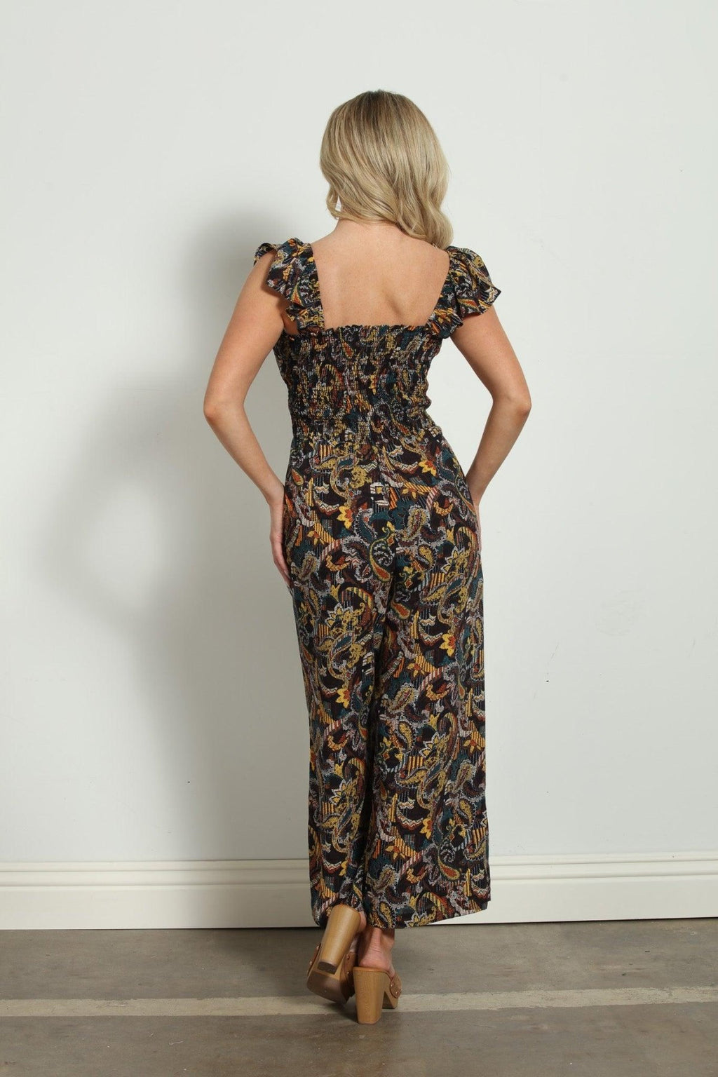 backside of woman in multicolored sleeveless jumpsuit
