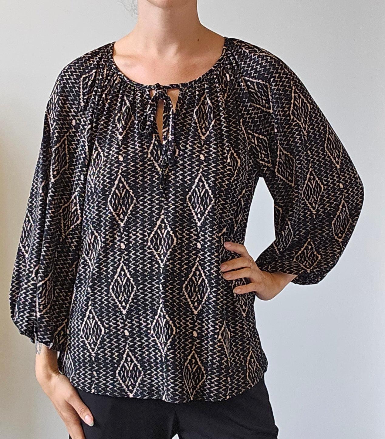 black and white long sleeve blouse on woman in black pants
