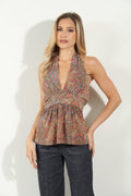 woman in multicolored sleeveless blouse and denim pants