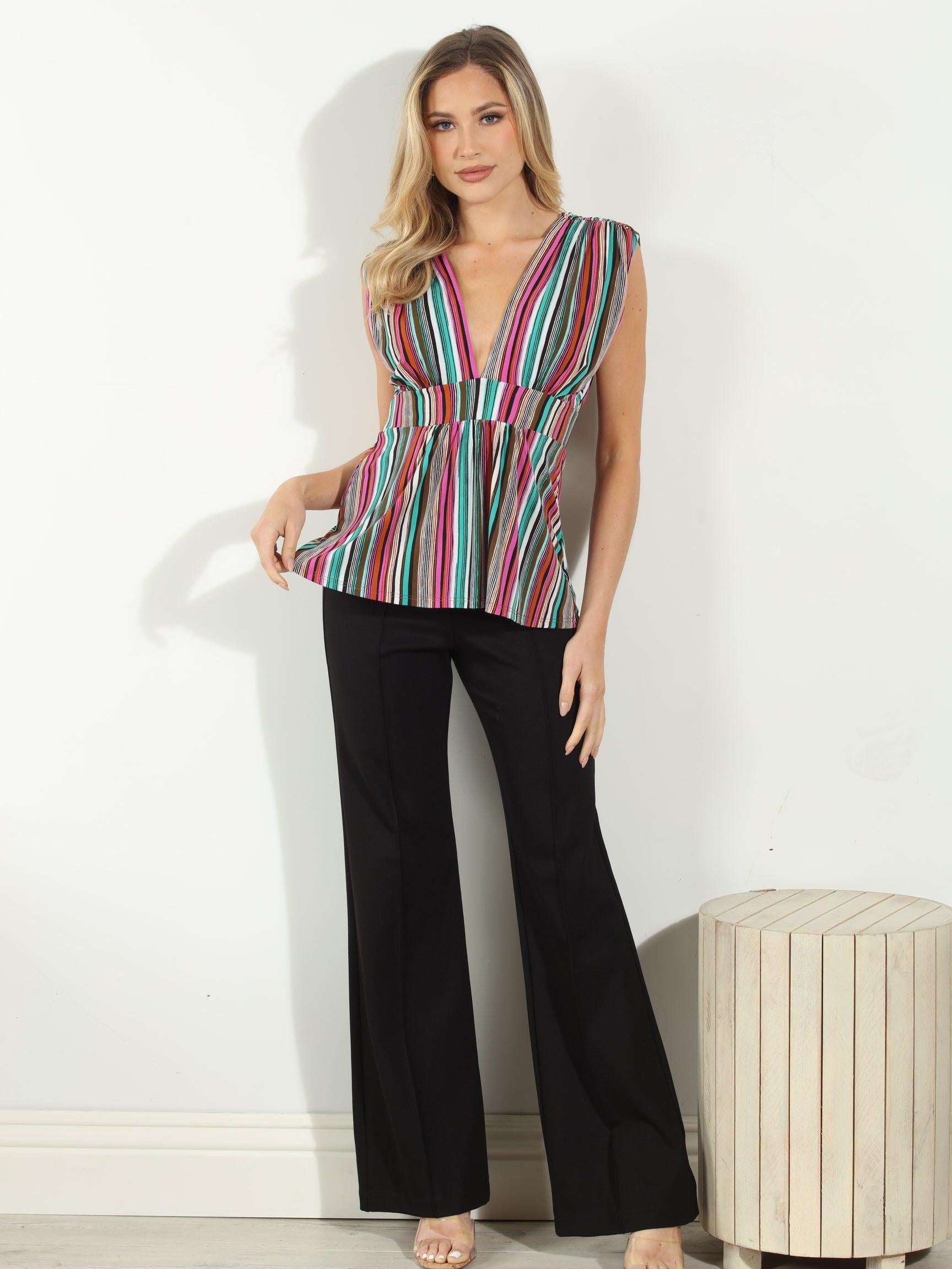 woman in multicolored sleeveless blouse and black pants
