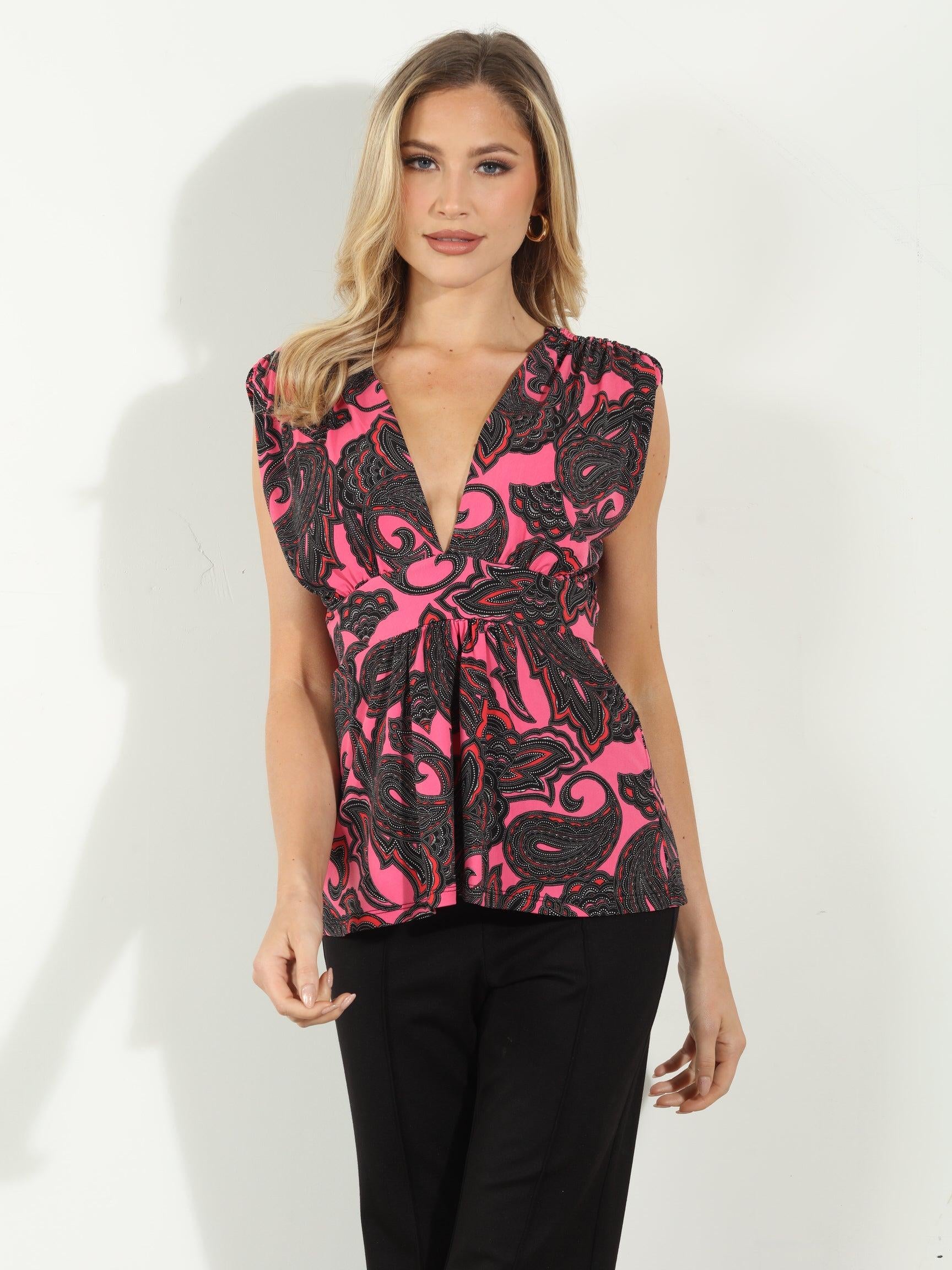 woman in pink and black sleeveless blouse and black pants
