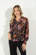multicolored long sleeve floral blouse on woman in black pants