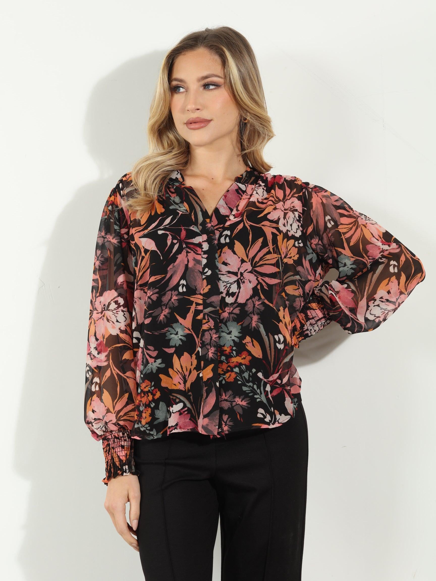 multicolored long sleeve floral blouse on woman in black pants