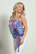 blue and purple strapless top on woman in white pants