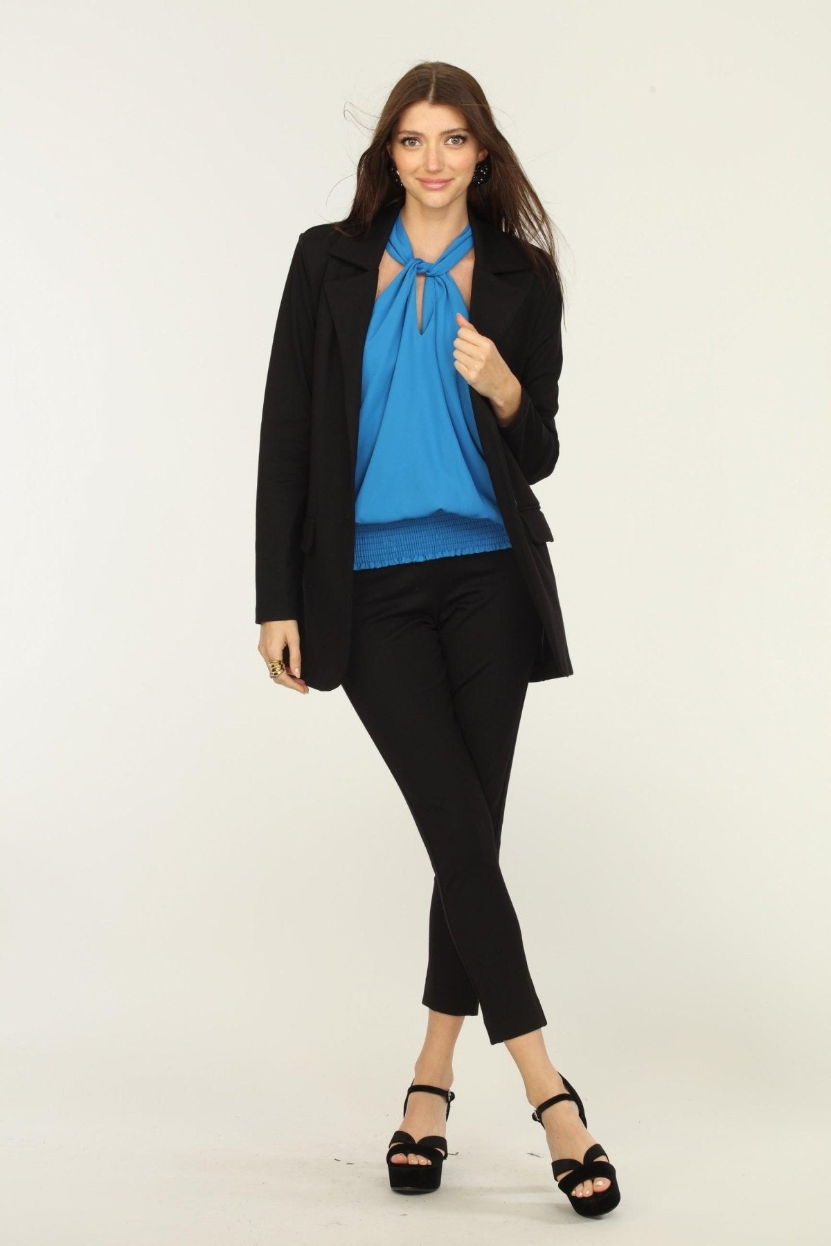 black blazer, blue blouse, and black pants on woman