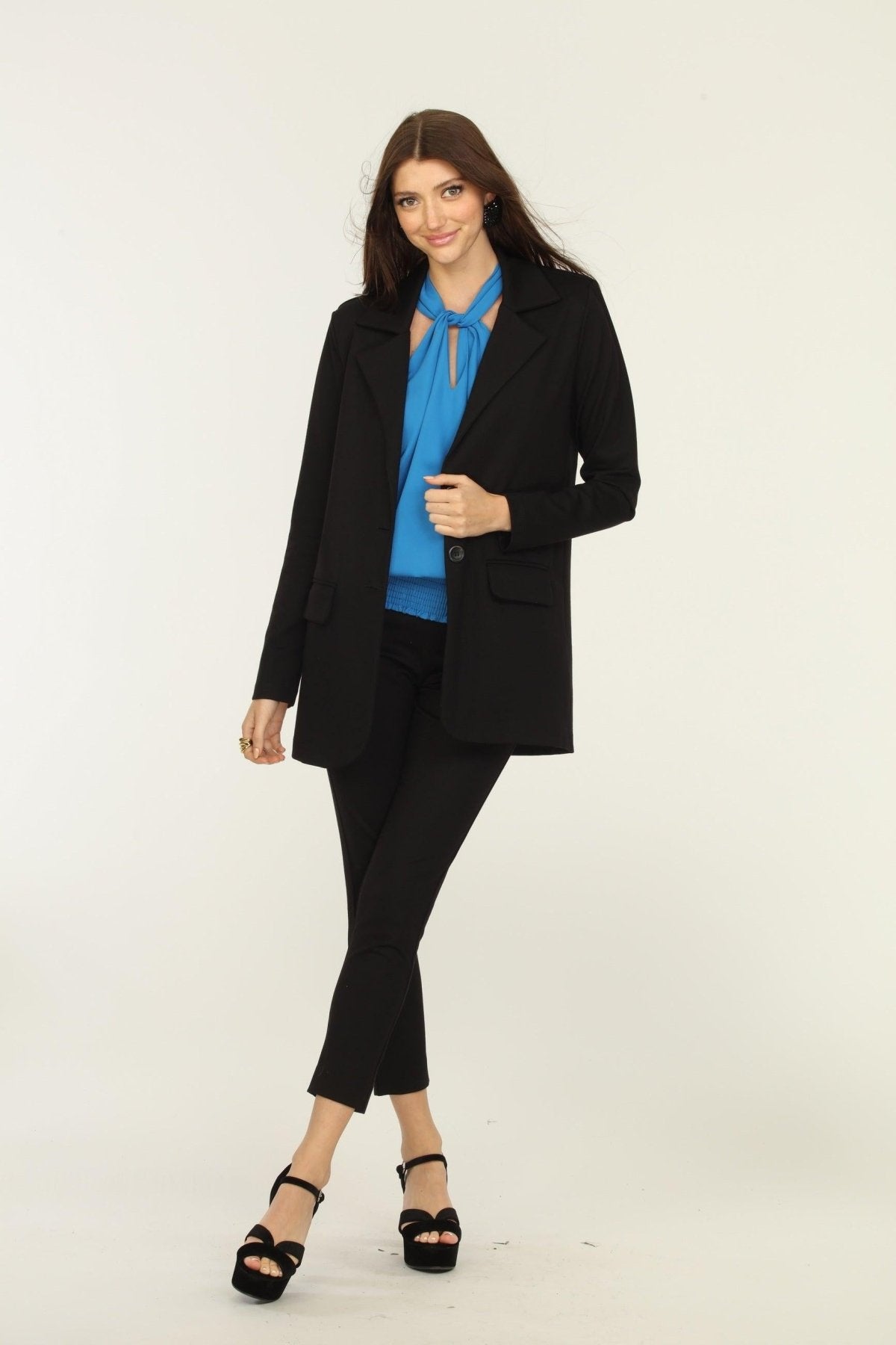 black blazer, blue top, and black pants on woman