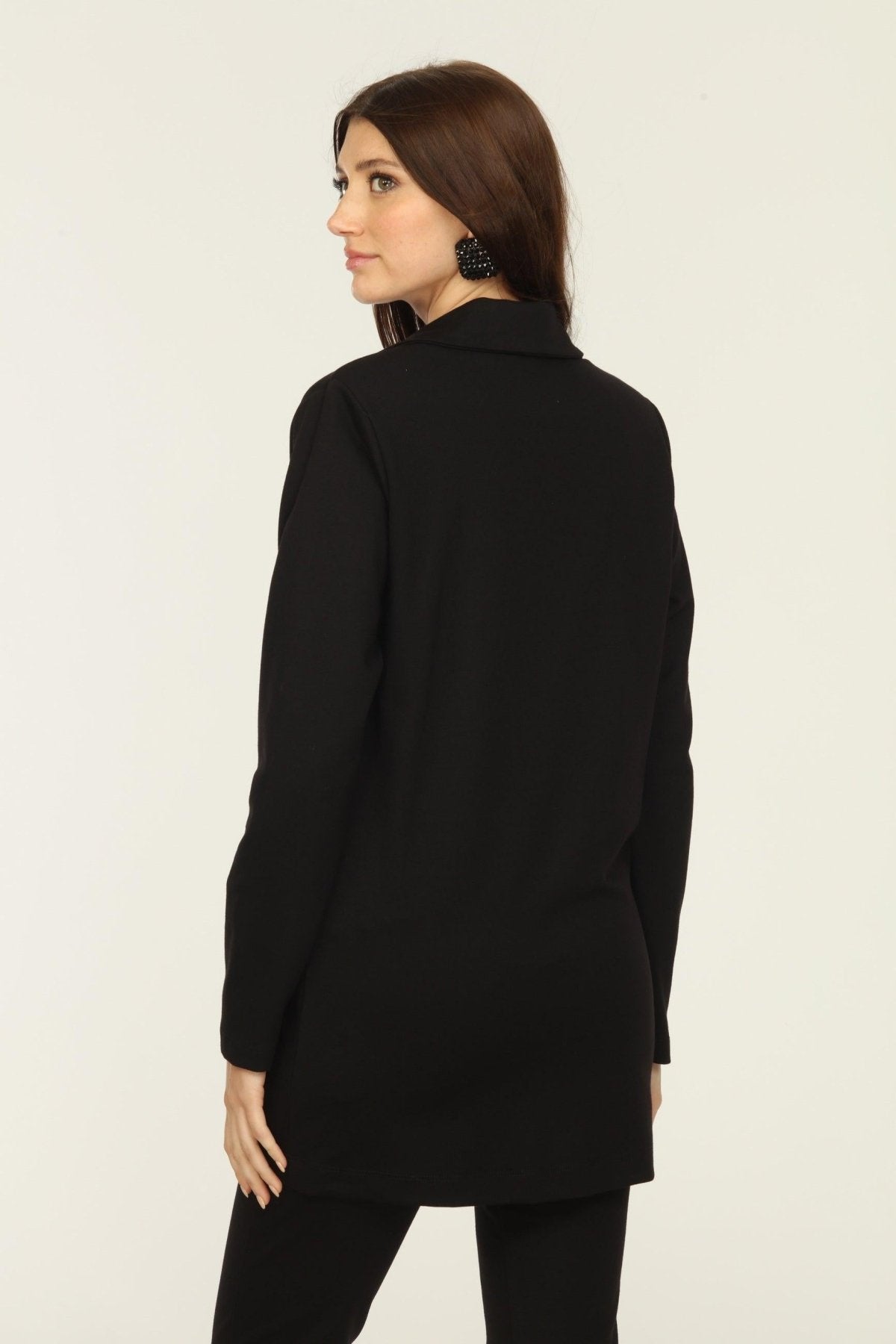 back side of black blazer and blue top on woman
