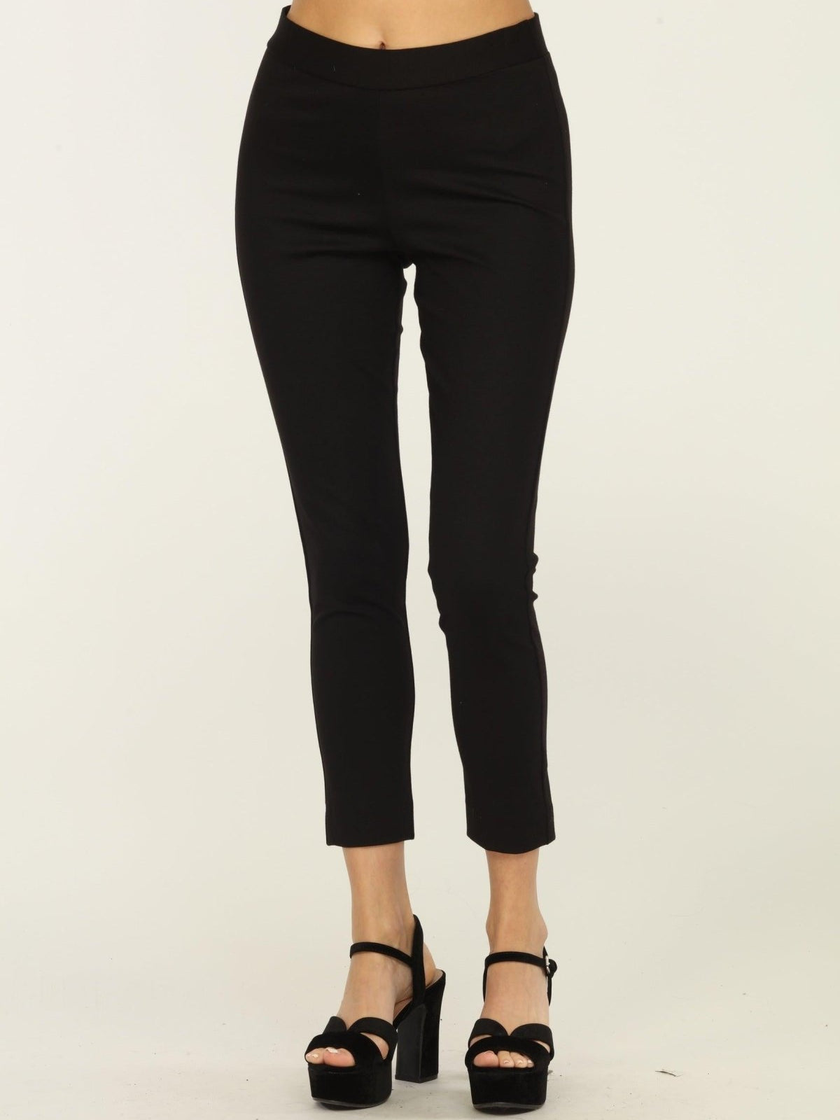 black tapered pants on woman in black heels