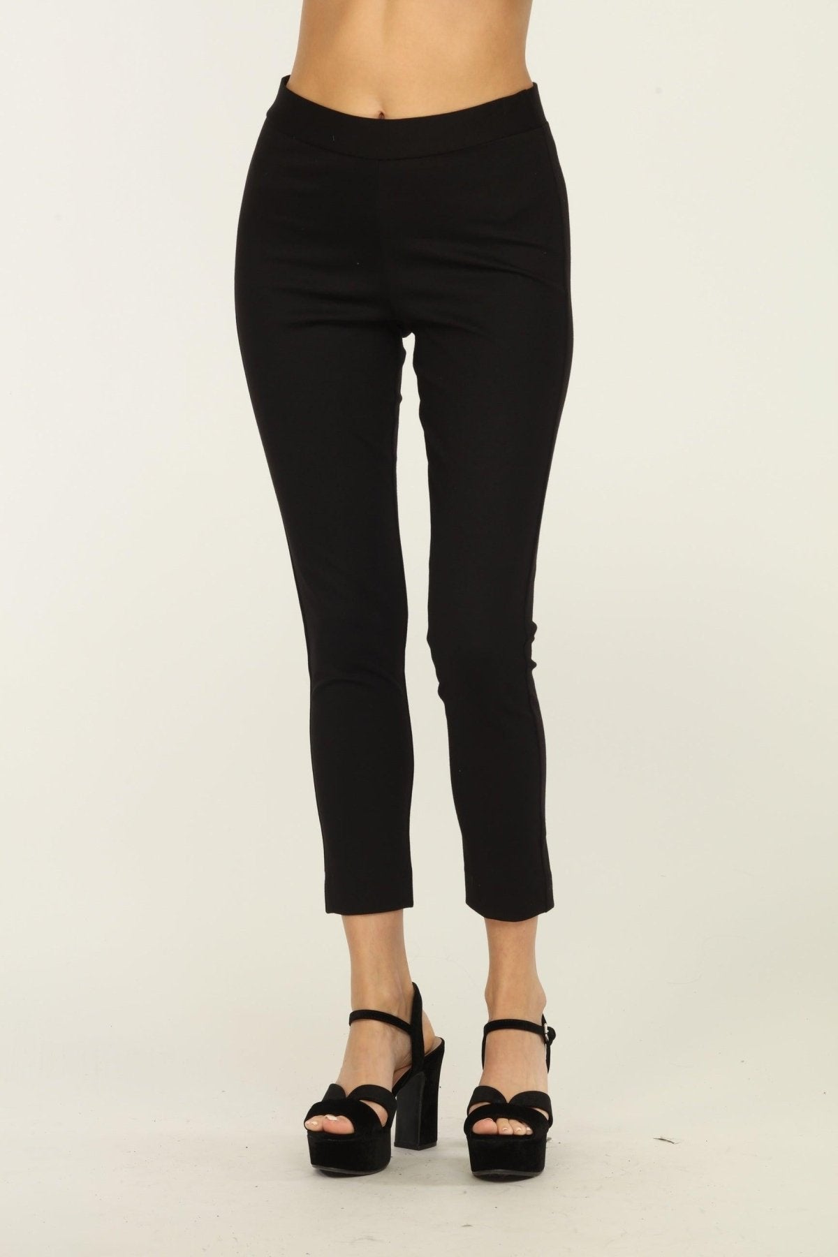 black tapered pants on woman in black heels