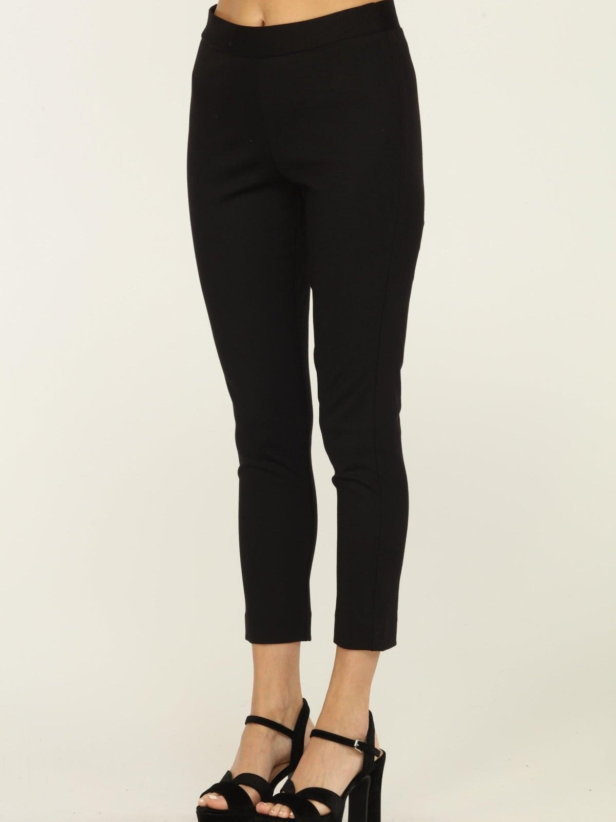 black tapered pants on woman in black heels