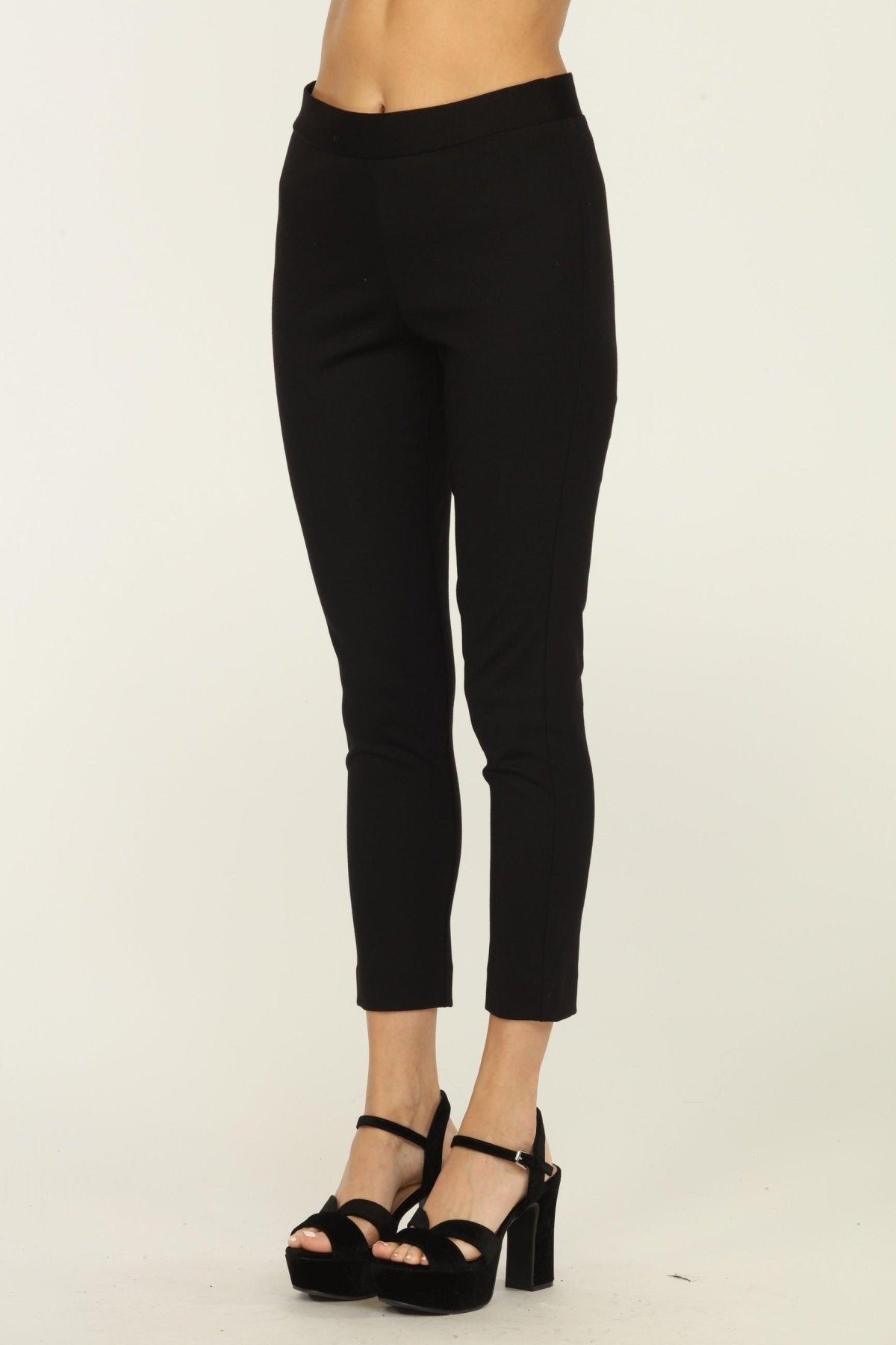 black tapered pants on woman in black heels