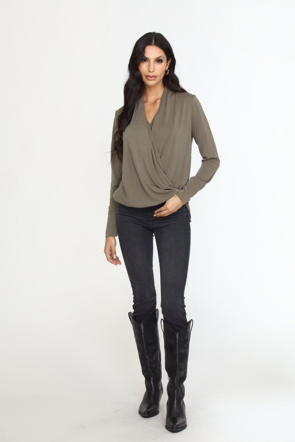 olive long sleeve draped blouse on woman in dark denim pants and black boots