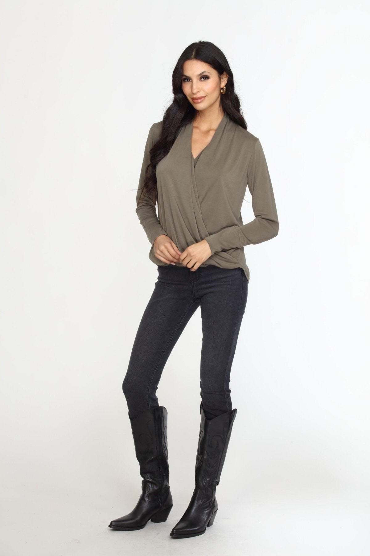 olive long sleeve draped blouse on woman in dark denim pants and black boots
