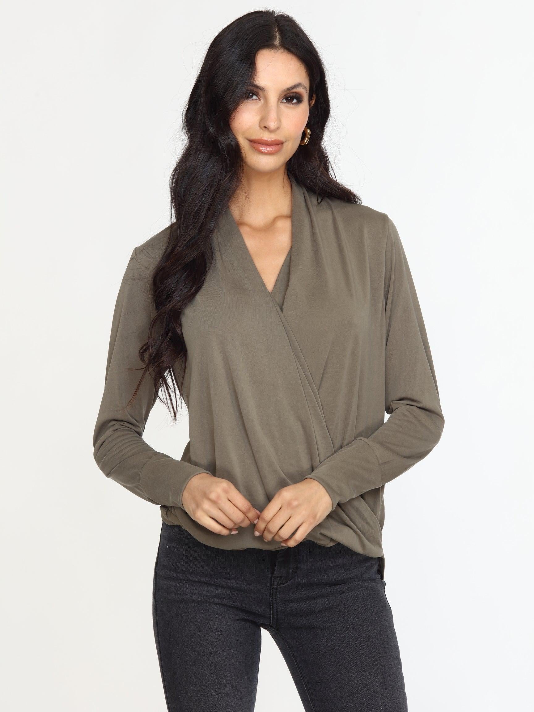 olive long sleeve draped blouse on woman in dark denim pants