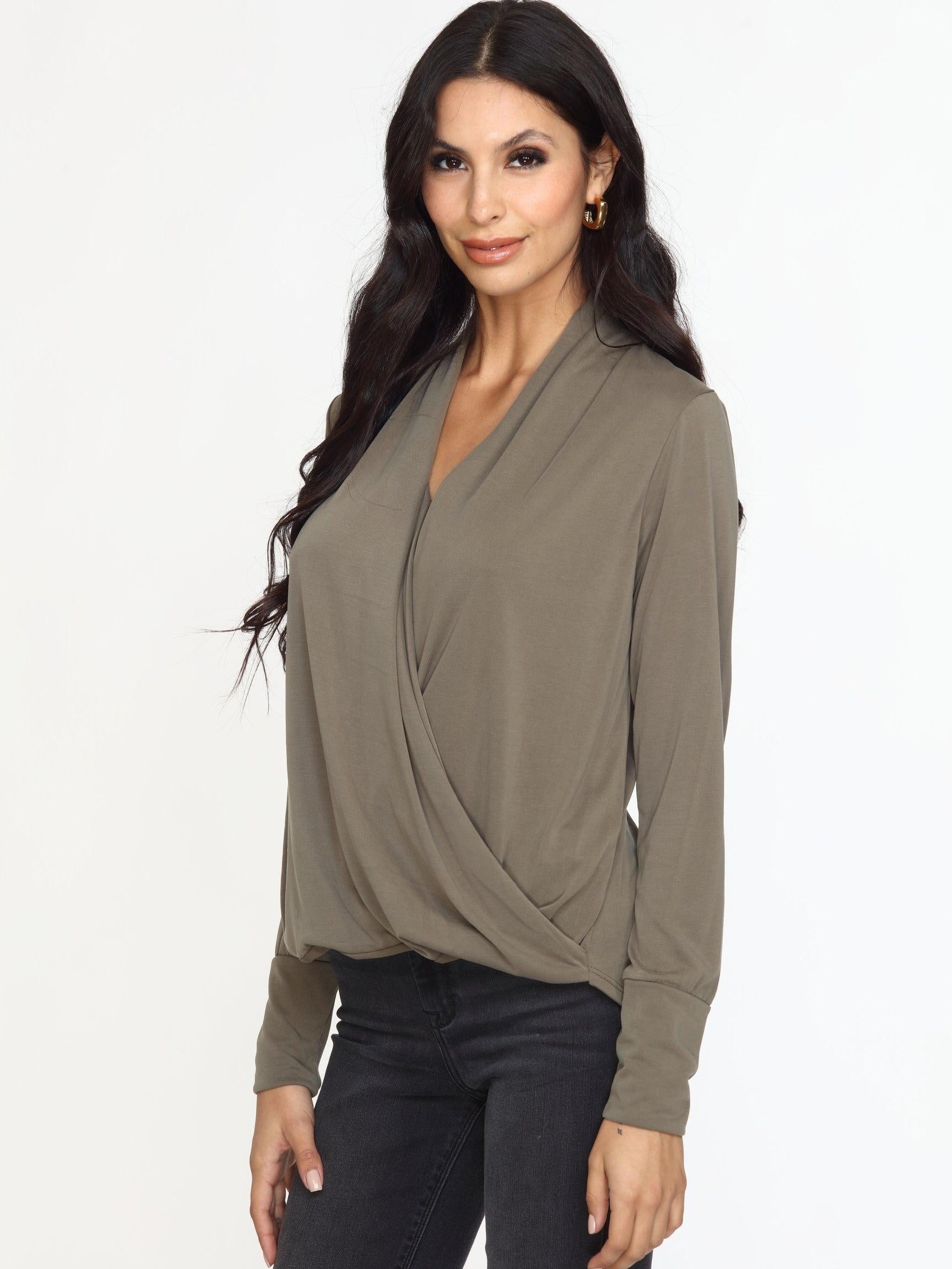 olive long sleeve draped blouse on woman in dark denim pants