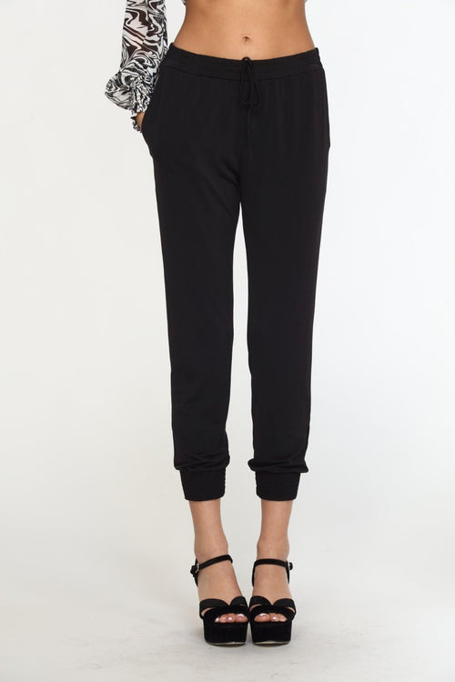 black tapered jogger pants on woman in black high heels