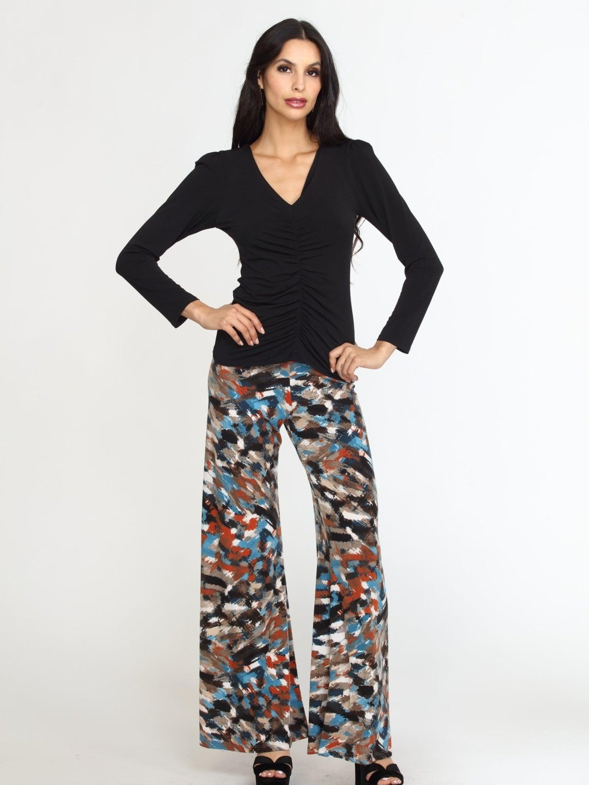 multicolored wideleg pants on woman in black heels and black long sleeve top