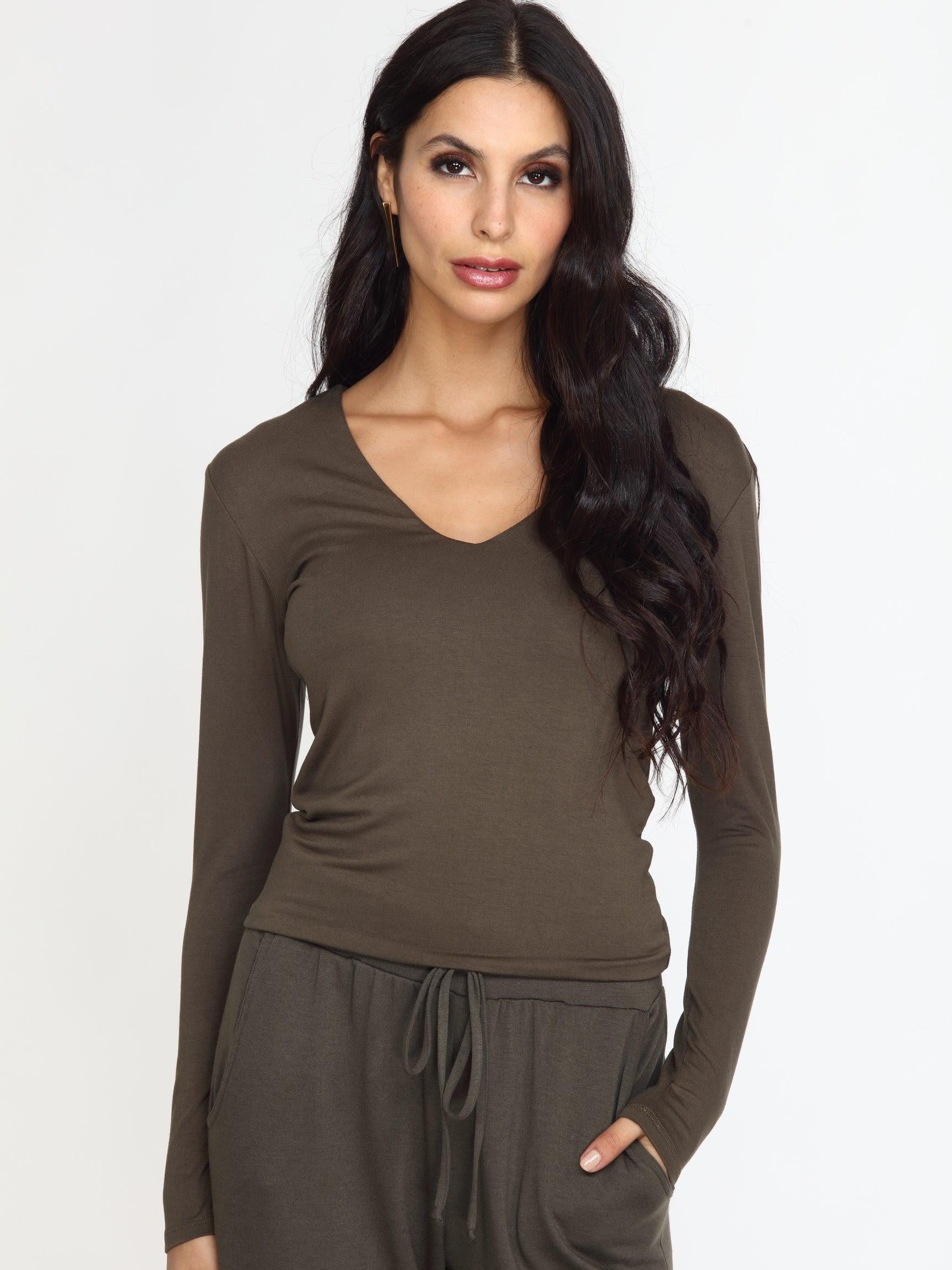 olive long sleeve vneck top on woman in olive pants