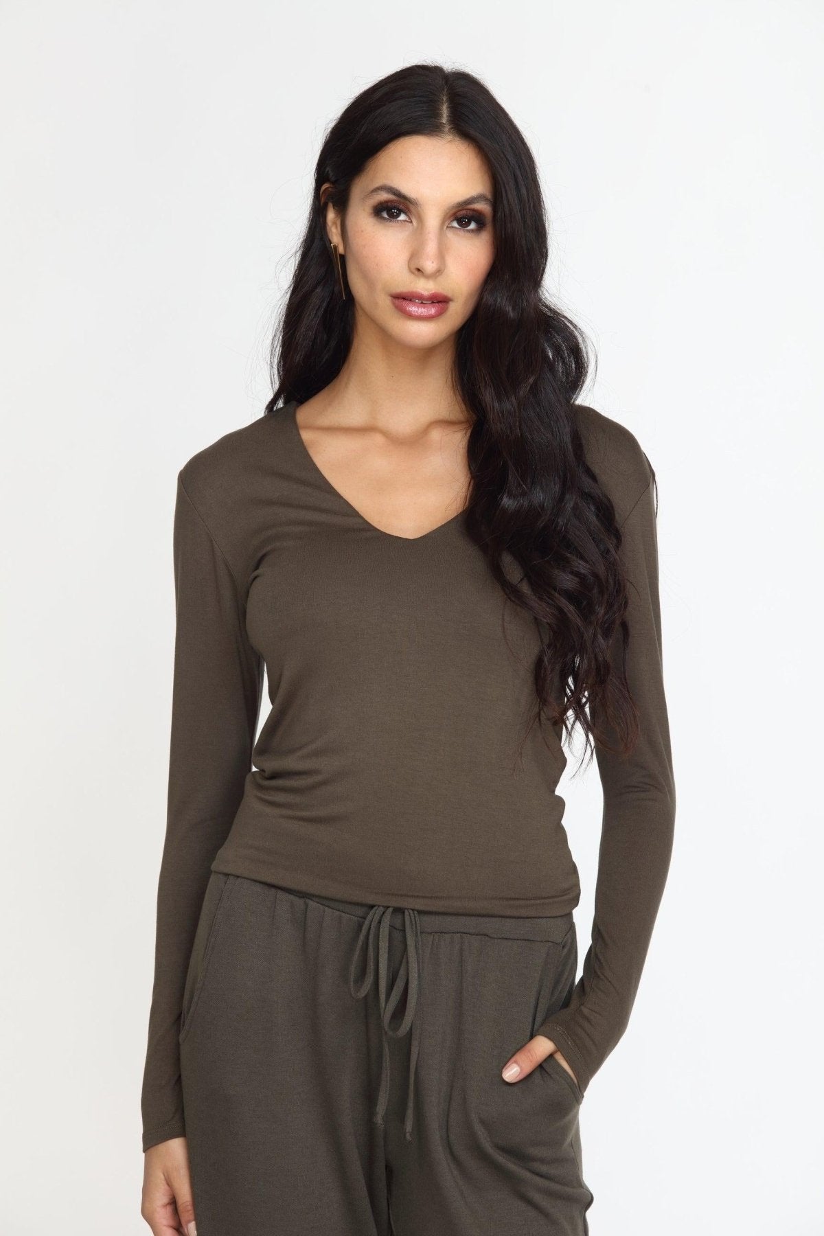olive long sleeve vneck top on woman in olive pants