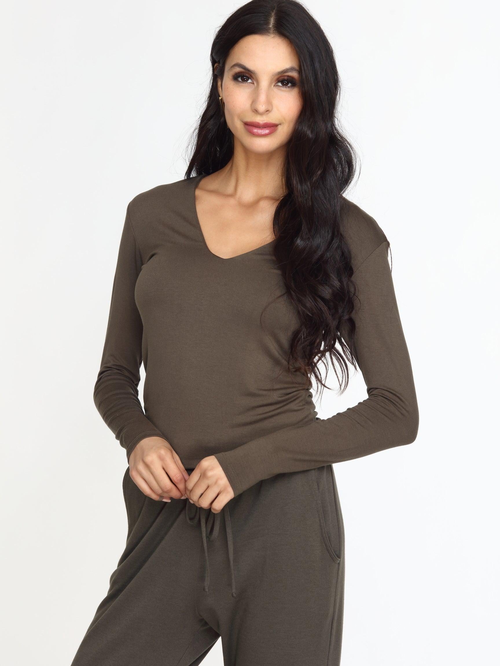 olive long sleeve vneck top on woman in olive pants
