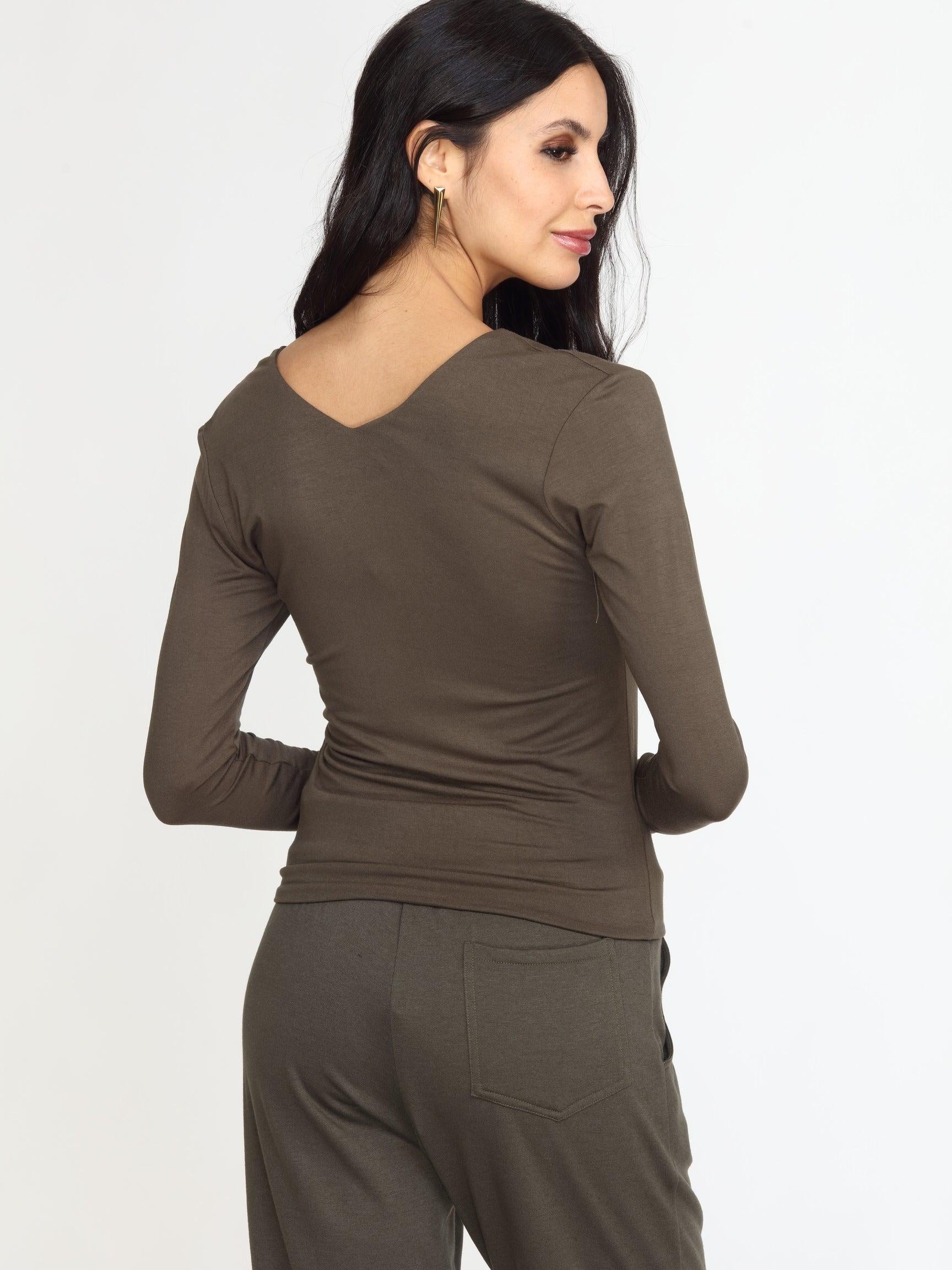 back side of olive long sleeve vneck top on woman in olive pants