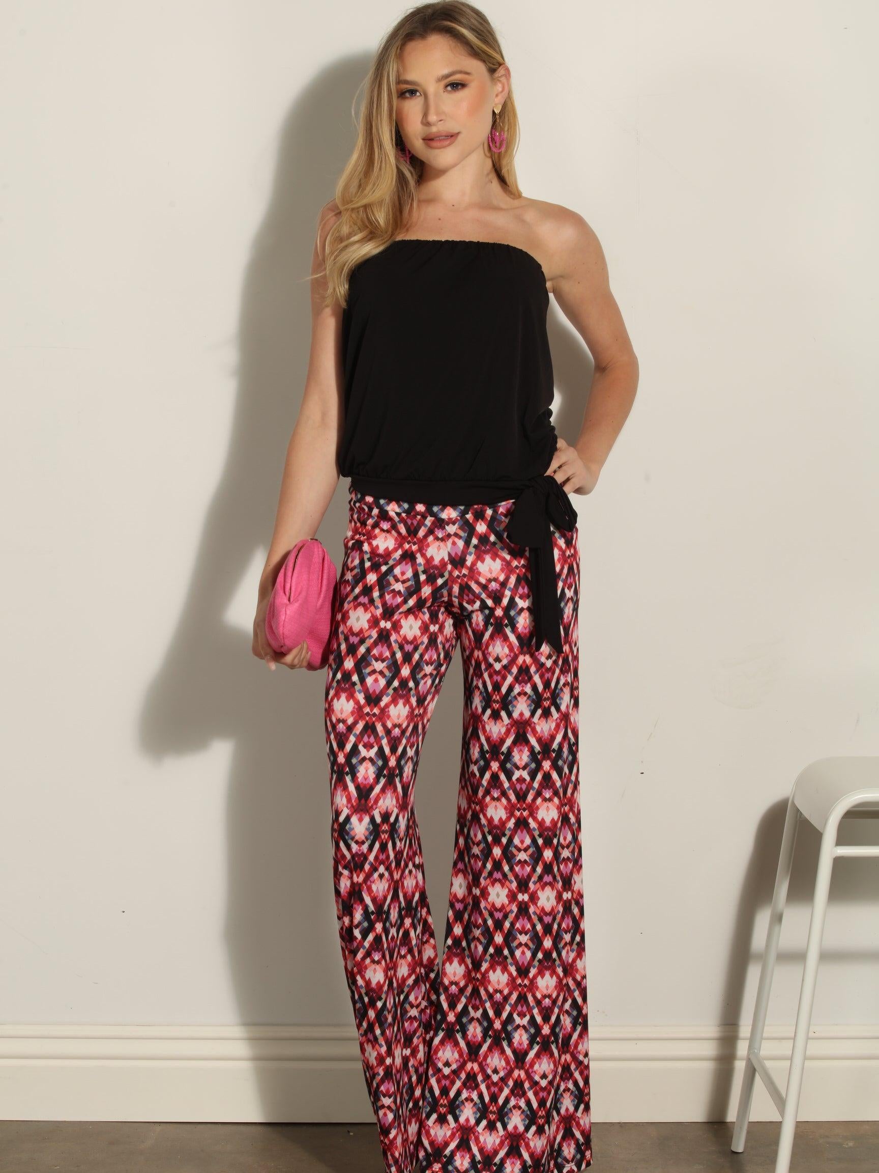 strapless top and multicolored pants on woman holding pink clutch