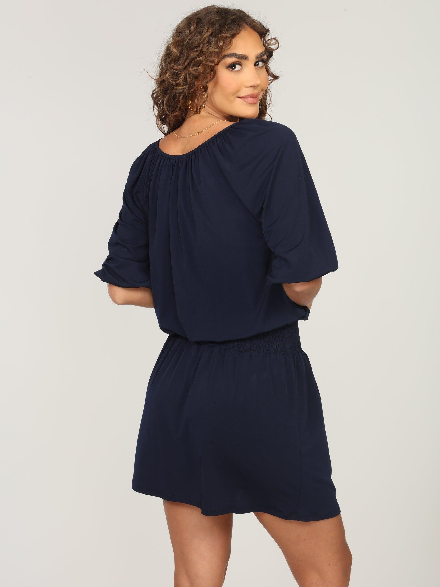 back side of navy dress with sleeves on woman