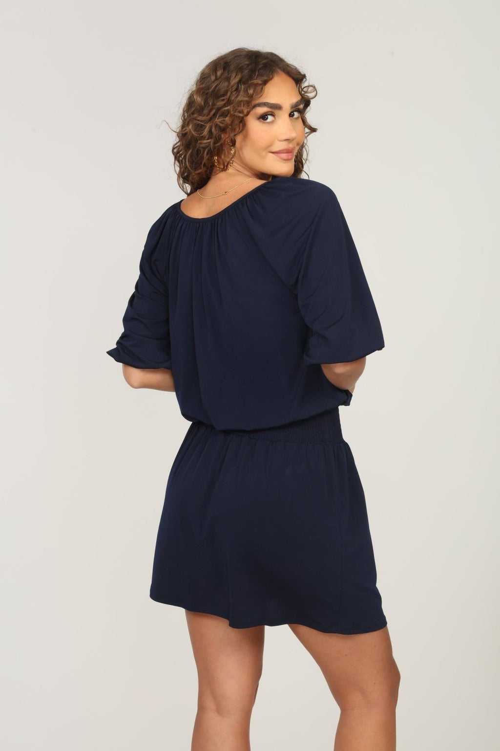 back side of navy dress with sleeves on woman