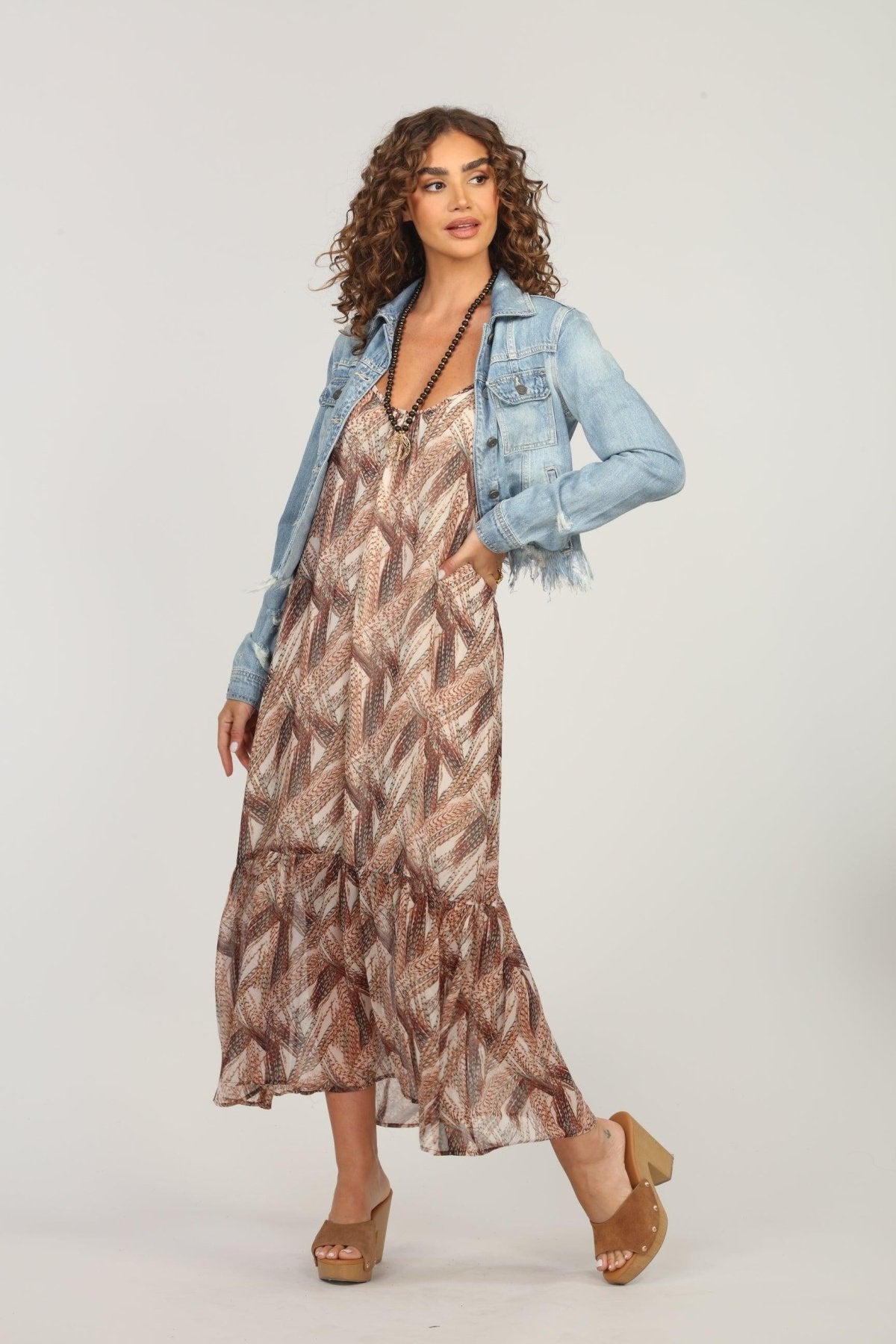 multicolored maxi dress and jean jacket on woman