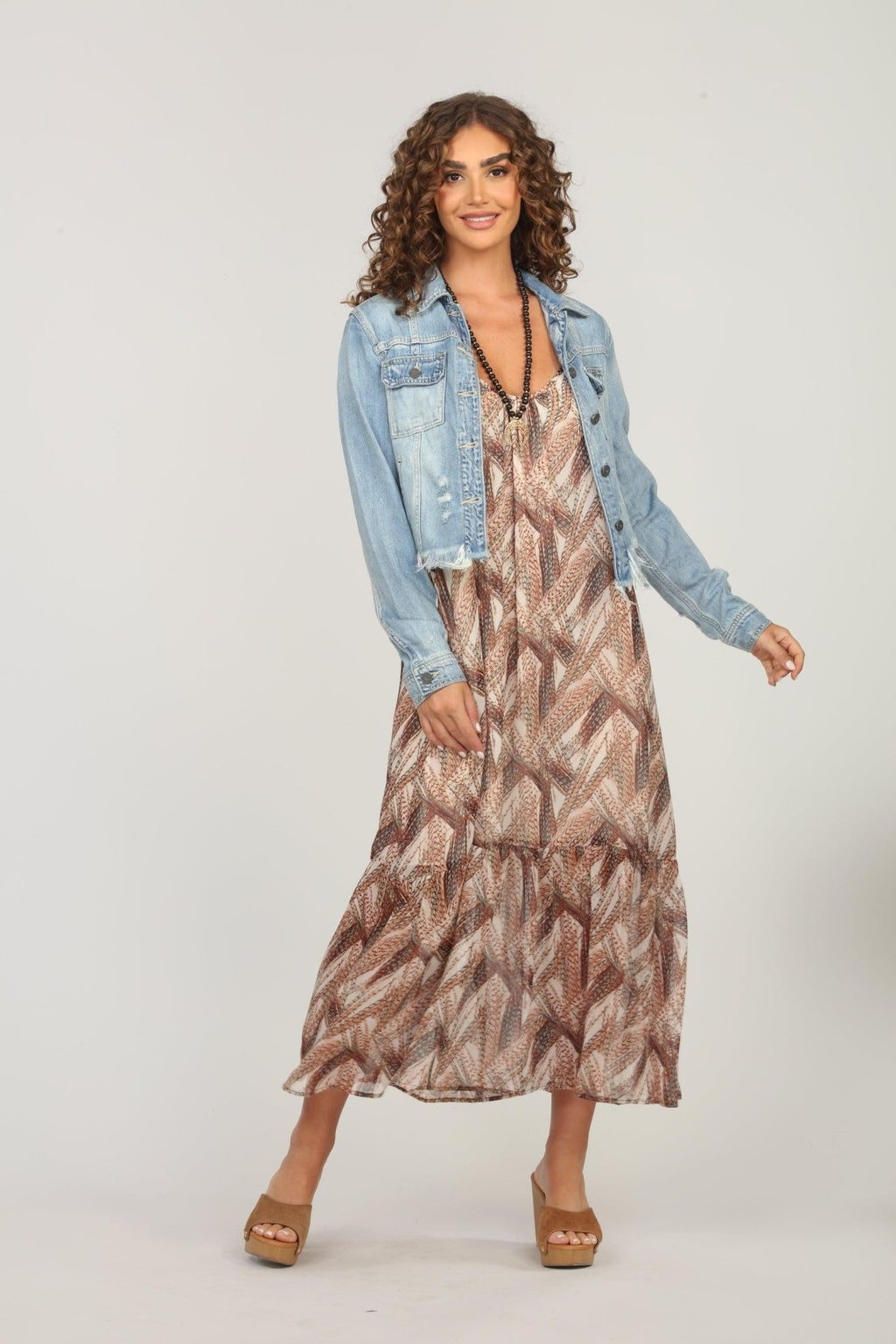 multicolored maxi dress and jean jacket on woman