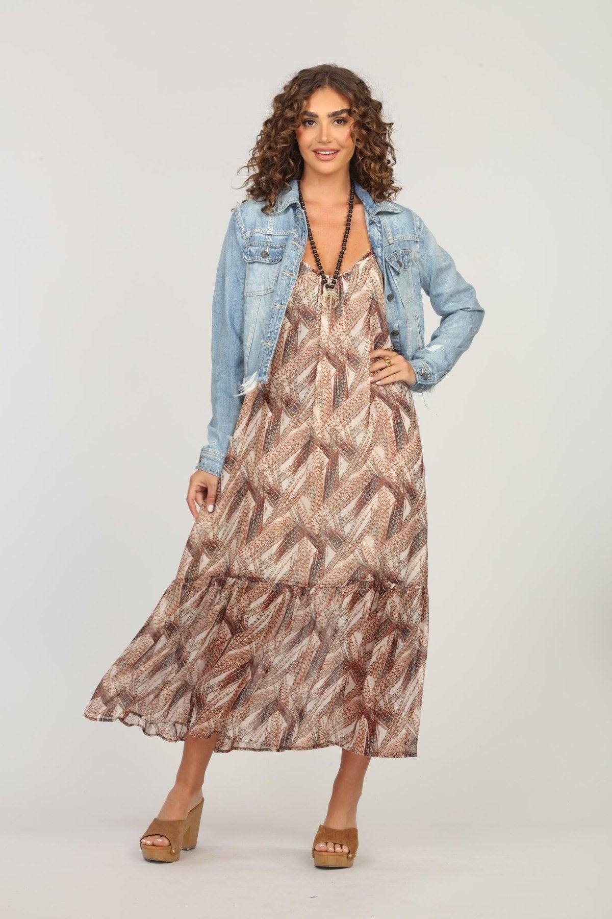 multicolored maxi dress and jean jacket on woman