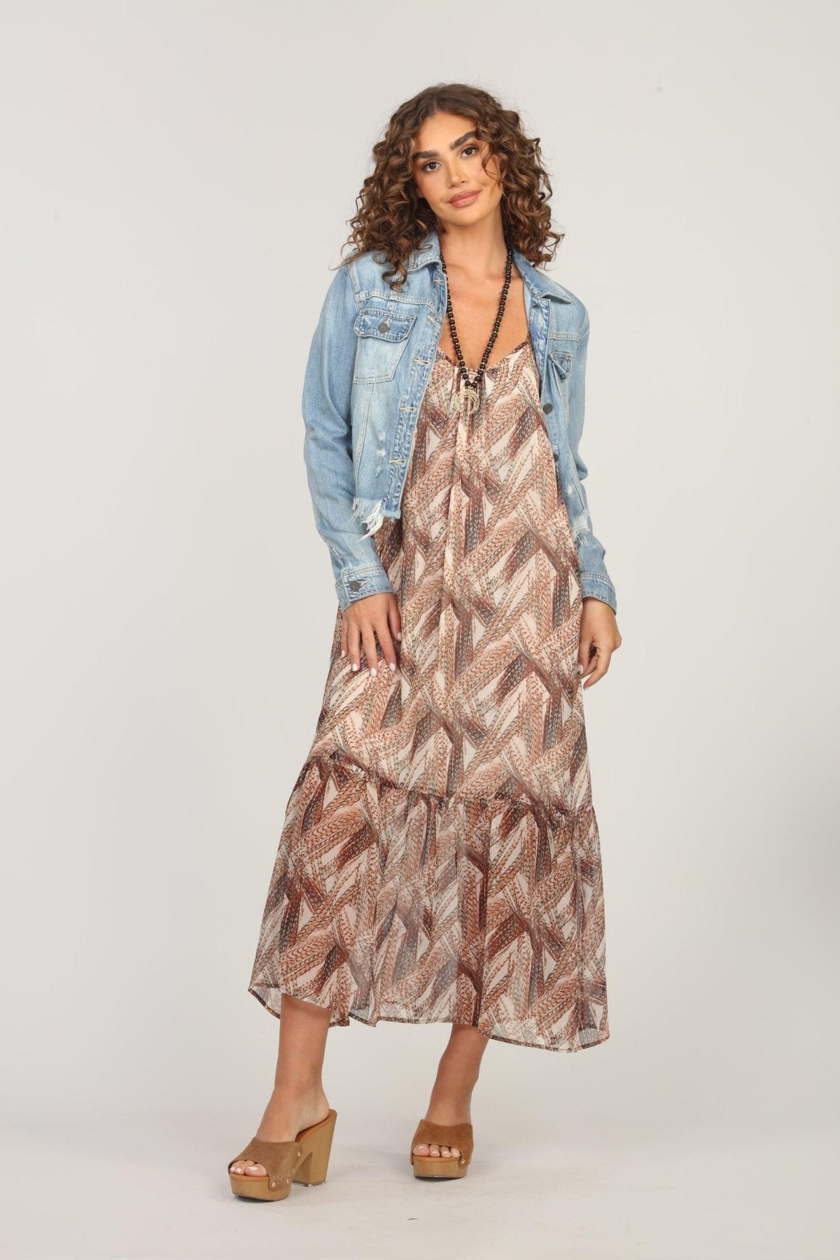 multicolored maxi dress and jean jacket on woman