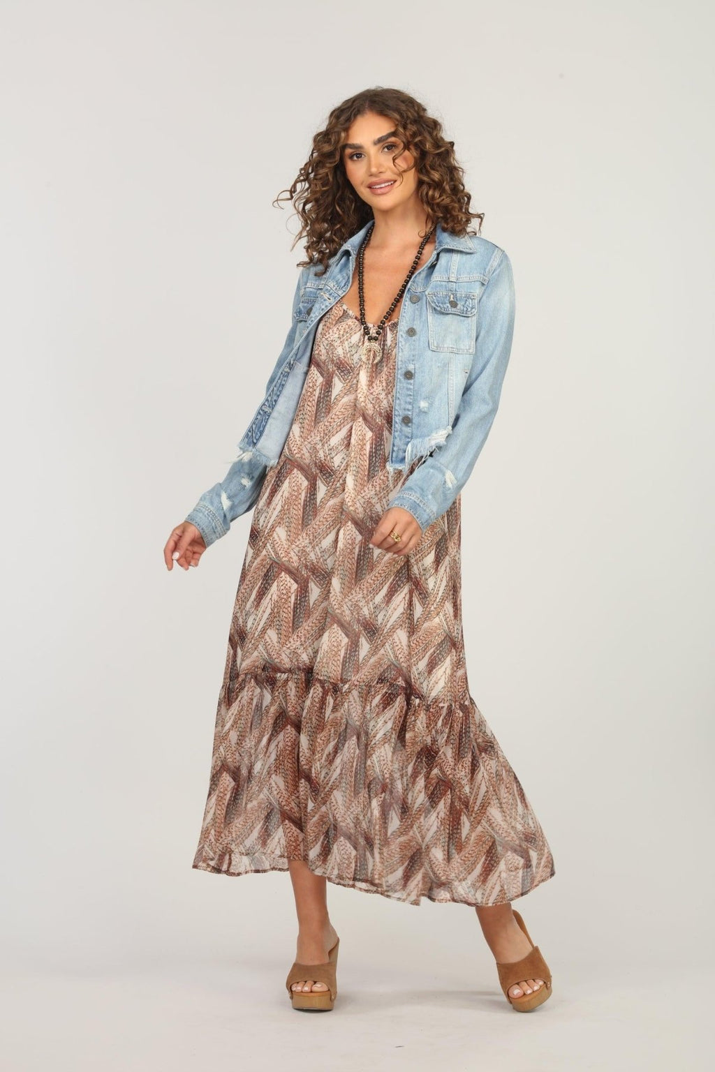 multicolored maxi dress and jean jacket on woman