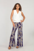 white sleeveless blouse and multicolored, printed, wide-legged pants on woman