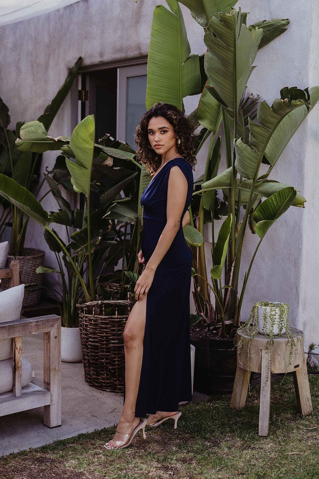 navy sleeveless maxi dress with deep neckline and side slit on woman