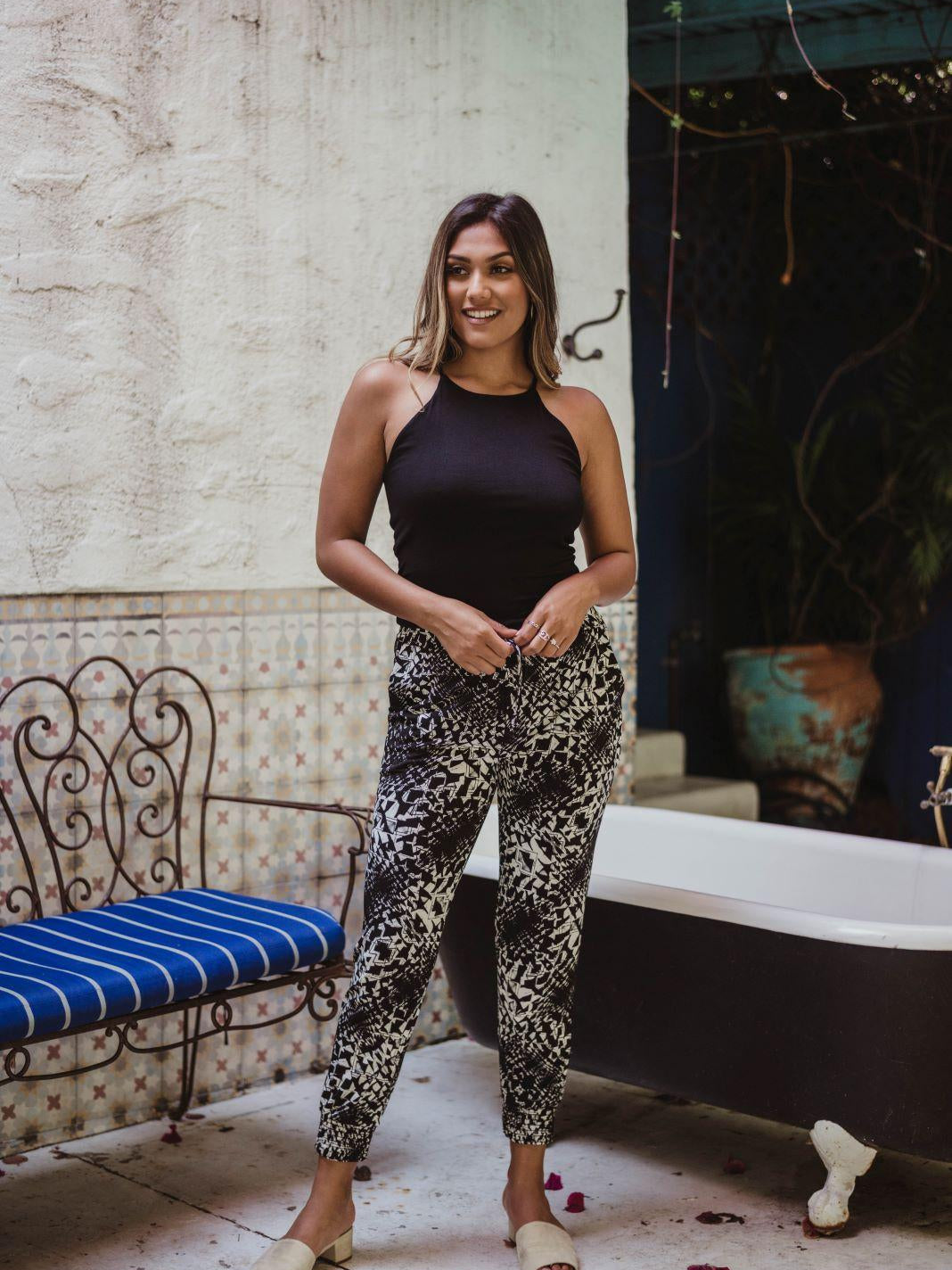 black sleeveless tank top and printed tapered pants on woman
