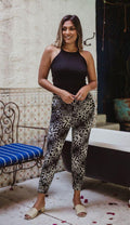black sleeveless tank top and printed tapered pants on woman