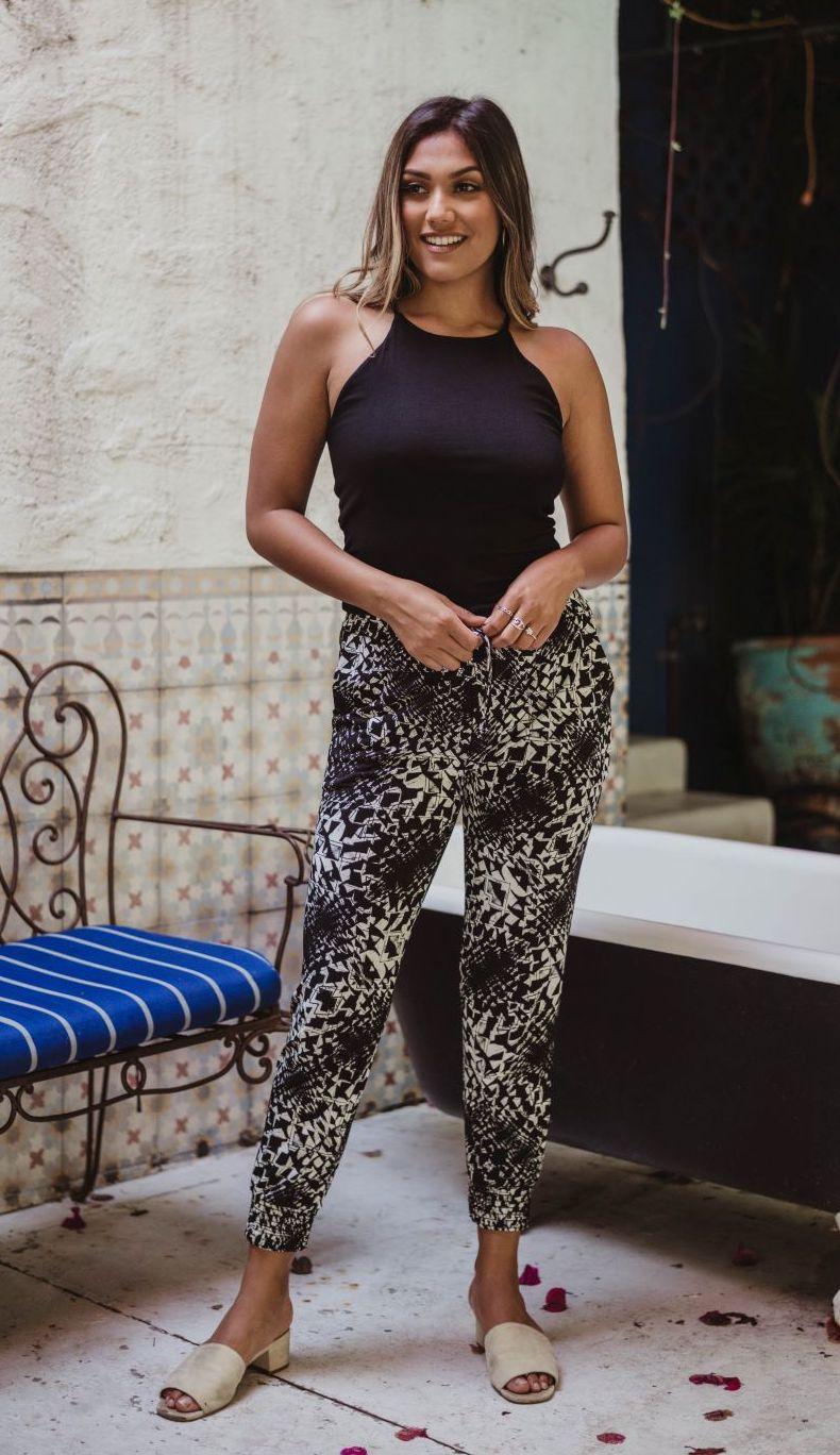 black sleeveless tank top and printed tapered pants on woman