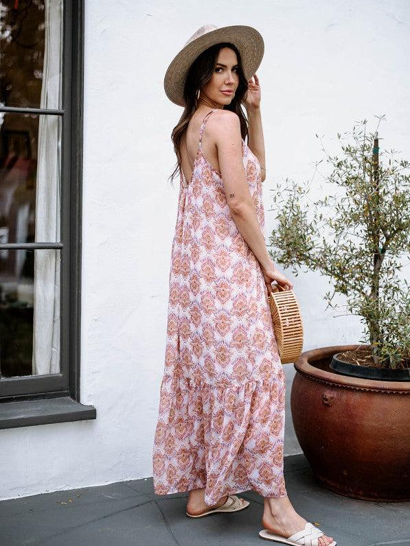 multicolored sleeveless maxi dress on woman in hat and holding purse