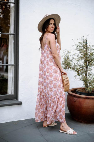 multicolored sleeveless maxi dress on woman in hat and holding purse